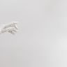 A sleek white robotic hand reaching out against a clean white background.