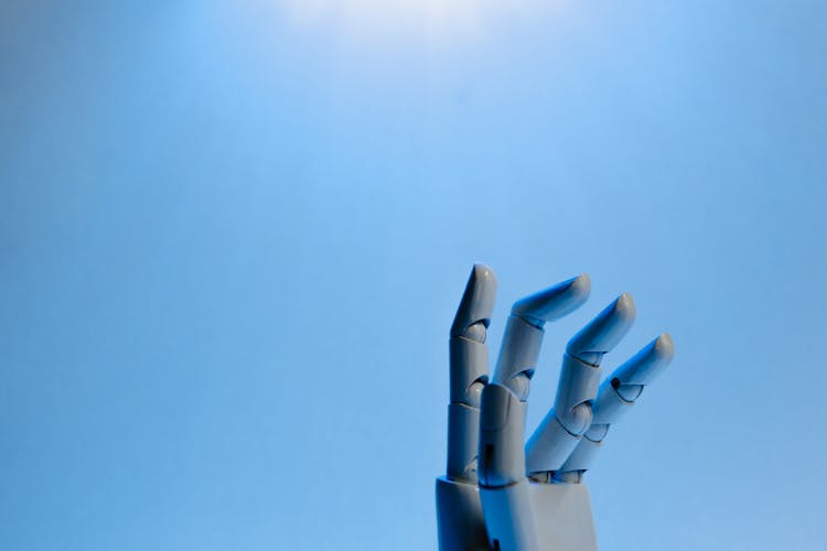 Robot Fingers On Blue Background