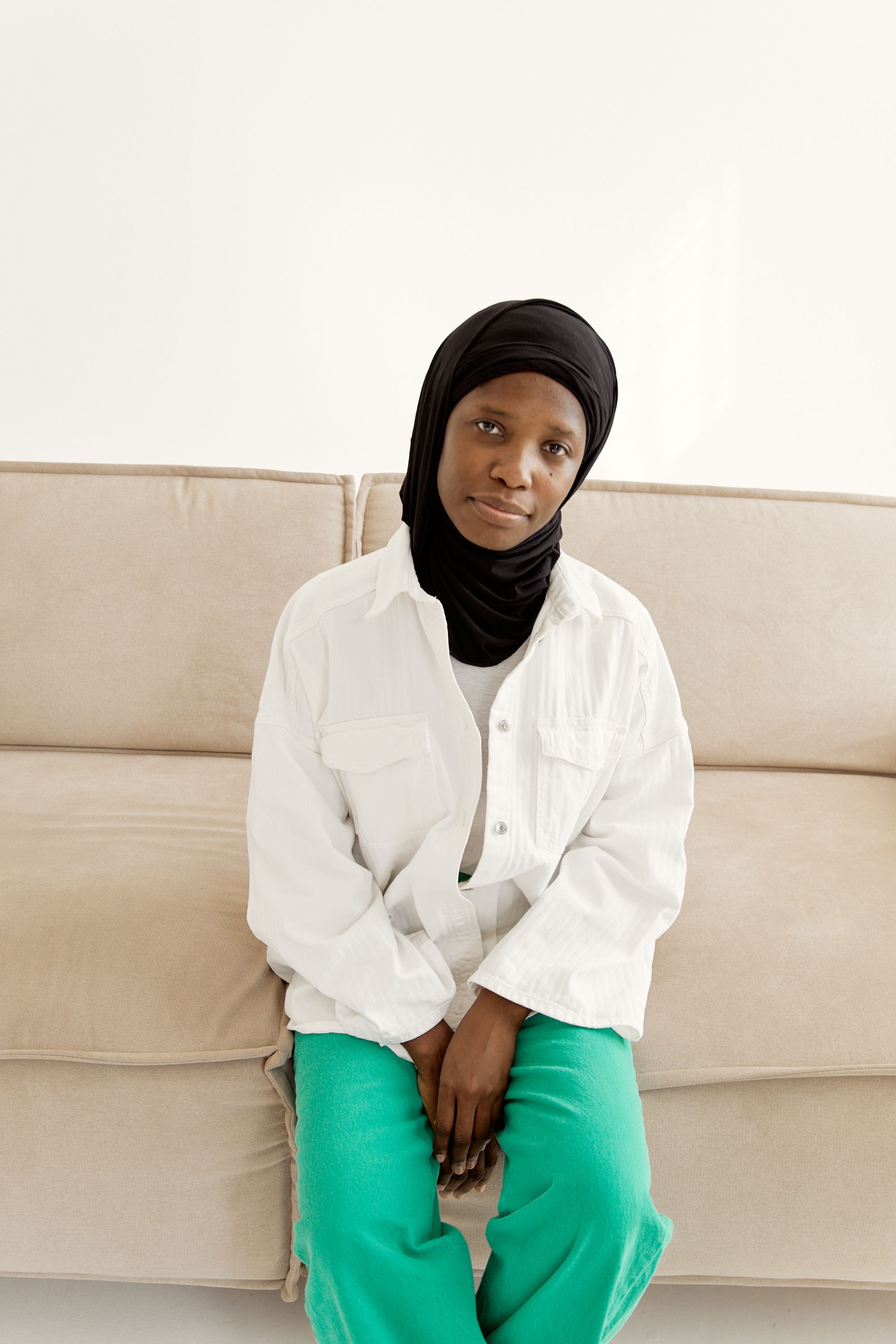 Woman Wearing a White Long Sleeves Sitting on a Couch · Free Stock Photo