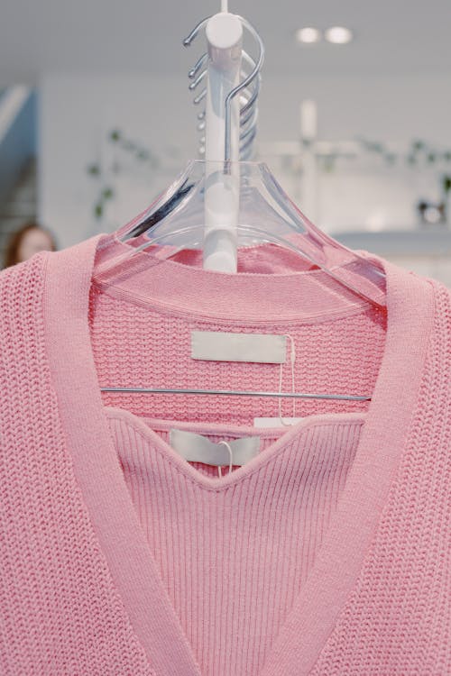 Pink V Neck Shirt on White Plastic Clothes Hanger
