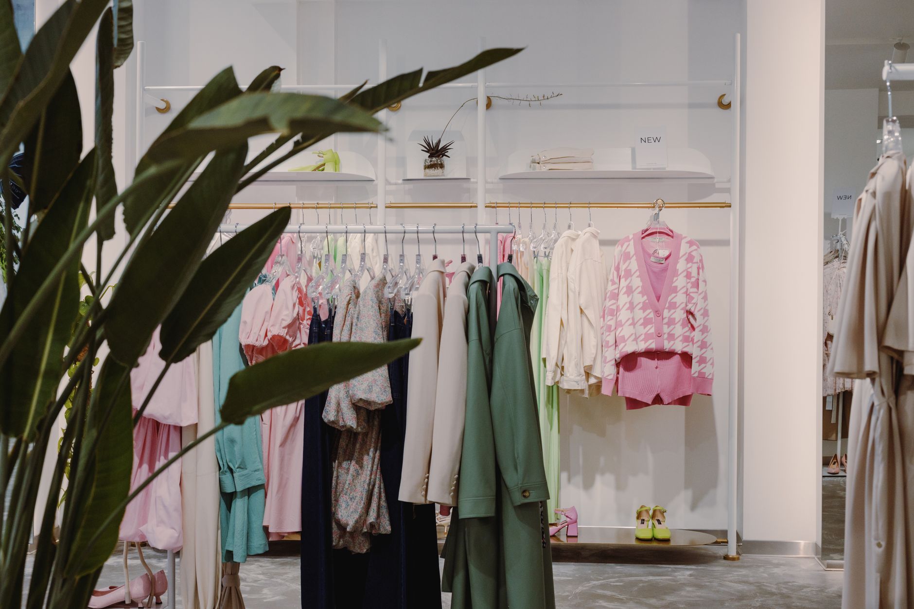 Vibrant clothing rack with diverse apparel in a contemporary boutique setting.