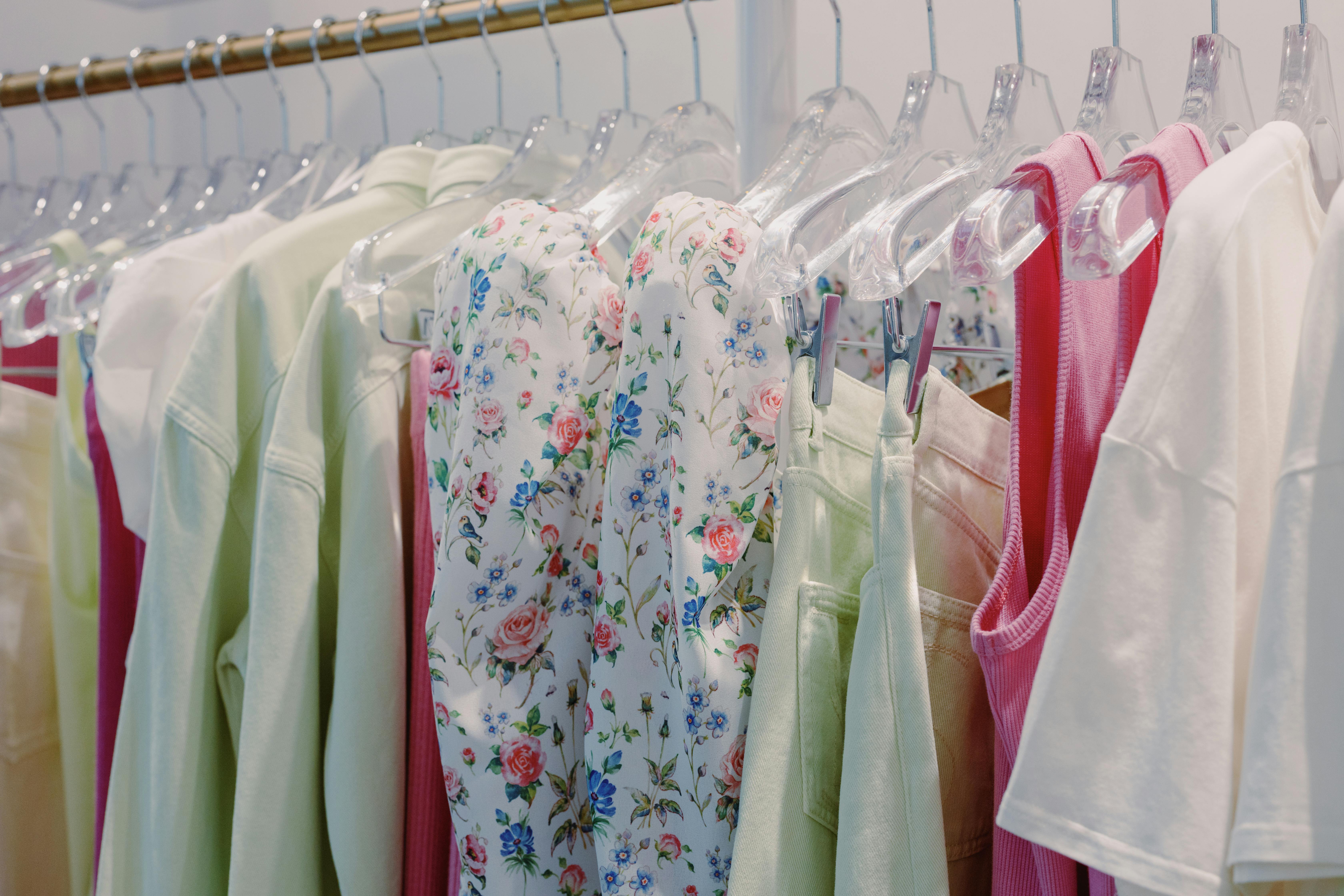 white blue and yellow floral dress hanging on clothing rack