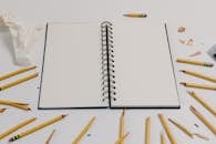 Smashed Pencils Around the White Notebook