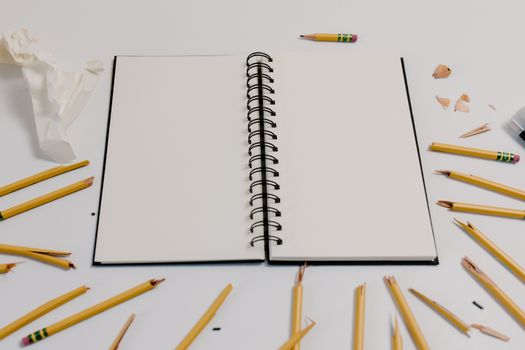 Smashed Pencils Around the White Notebook 