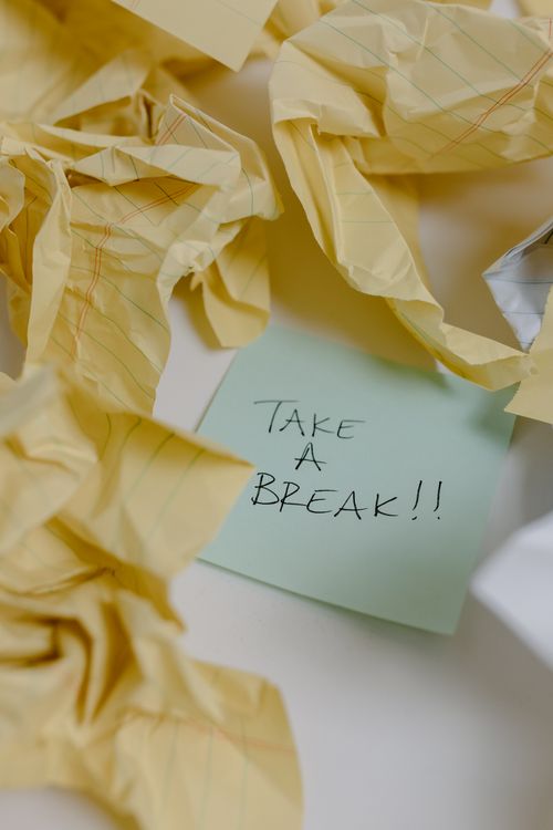 TextA Sticky Note around Crumpled Yellow Papers · Free Stock Photo