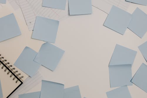 Free Sticky Notes Scattered on White Desk Stock Photo