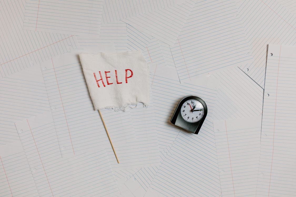 Overwork Clock Black and White Clock on White Papers · Free Stock Photo