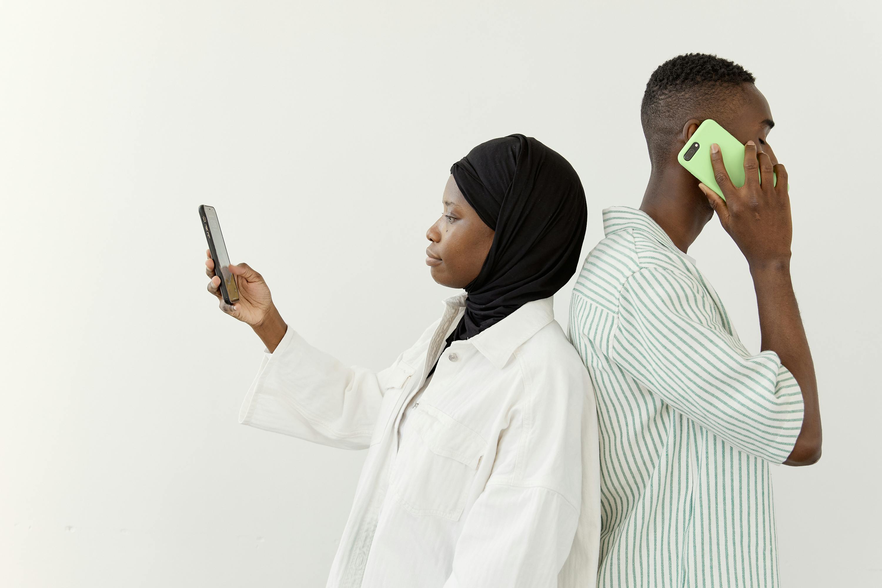 woman in hijab holding smartphone