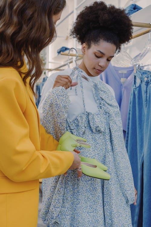 Woman in Yellow Blazer Matching Green Shoes to Blue Dress