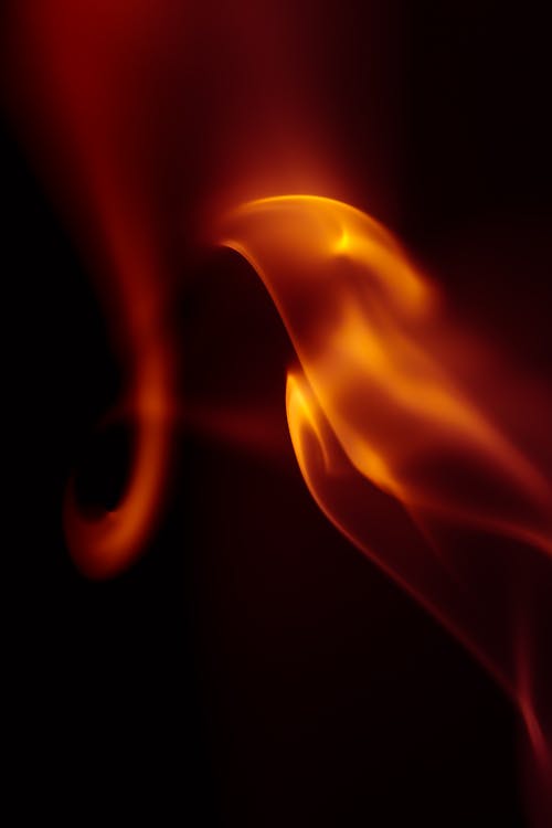 Free Close-up of artistic flames against a dark background, creating a dramatic effect. Stock Photo