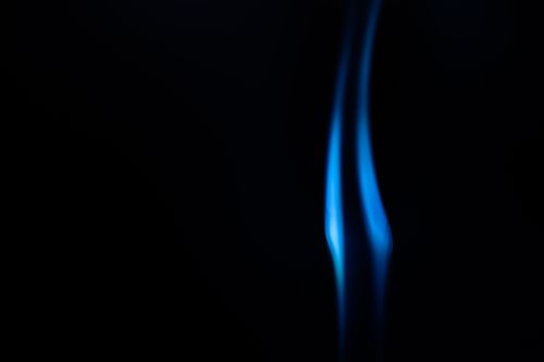 Free Smooth abstract blue flame against a black background with copy space. Stock Photo