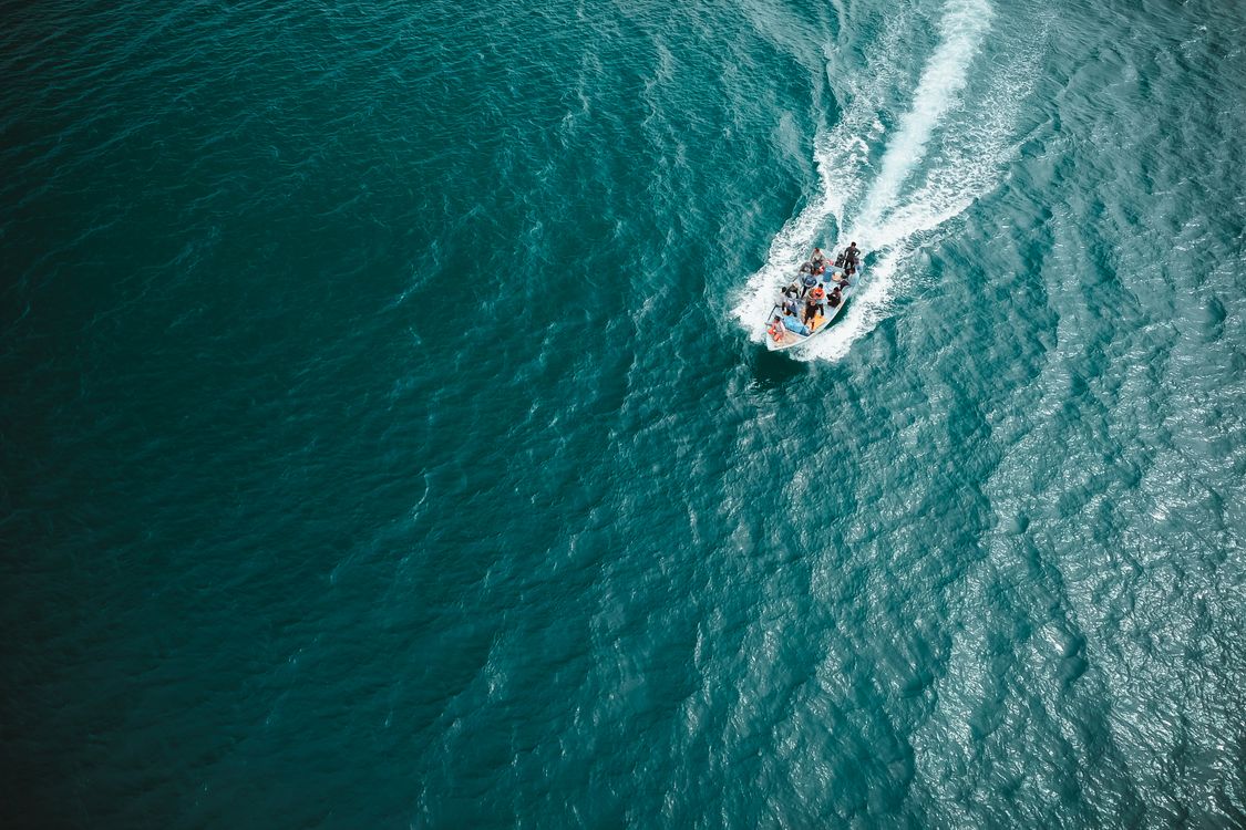 People Riding Boat on Body of Water · Free Stock Photo