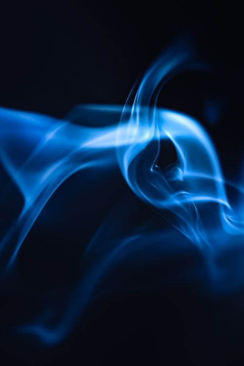 Free Artistic abstract image of blue smoke on a dark background. Stock Photo