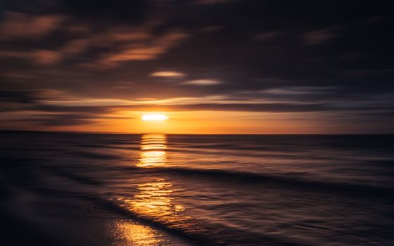 A breathtaking sunset over the ocean in Poland, capturing serene and tranquil moments.
