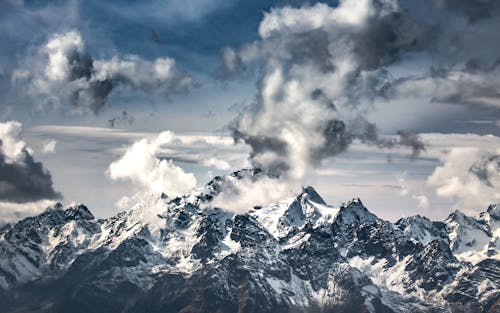 Free Snow Covered Mountains Under Cloudy Sky Stock Photo