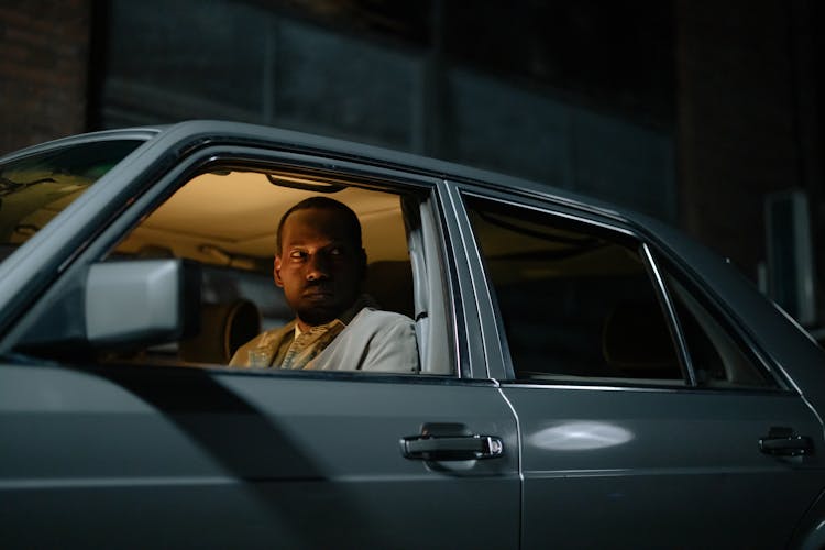 Man Sitting Inside A Car Looking Vigilant