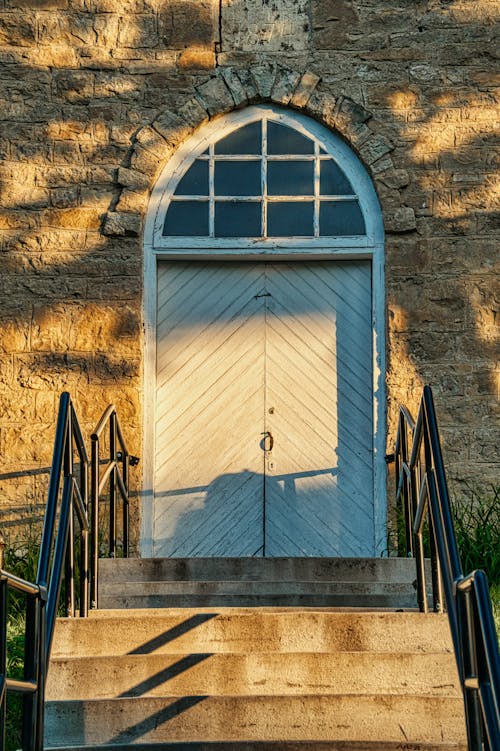 Wooden Door on Top of a Stairway