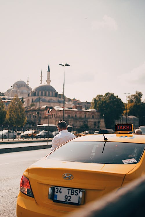 Free Yellow Taxi Parked on Roadside Stock Photo