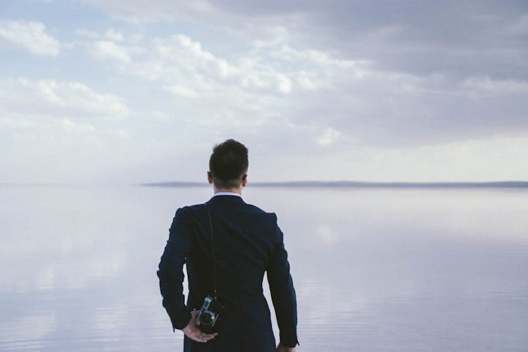 Back View Of A Photographer In A Suit