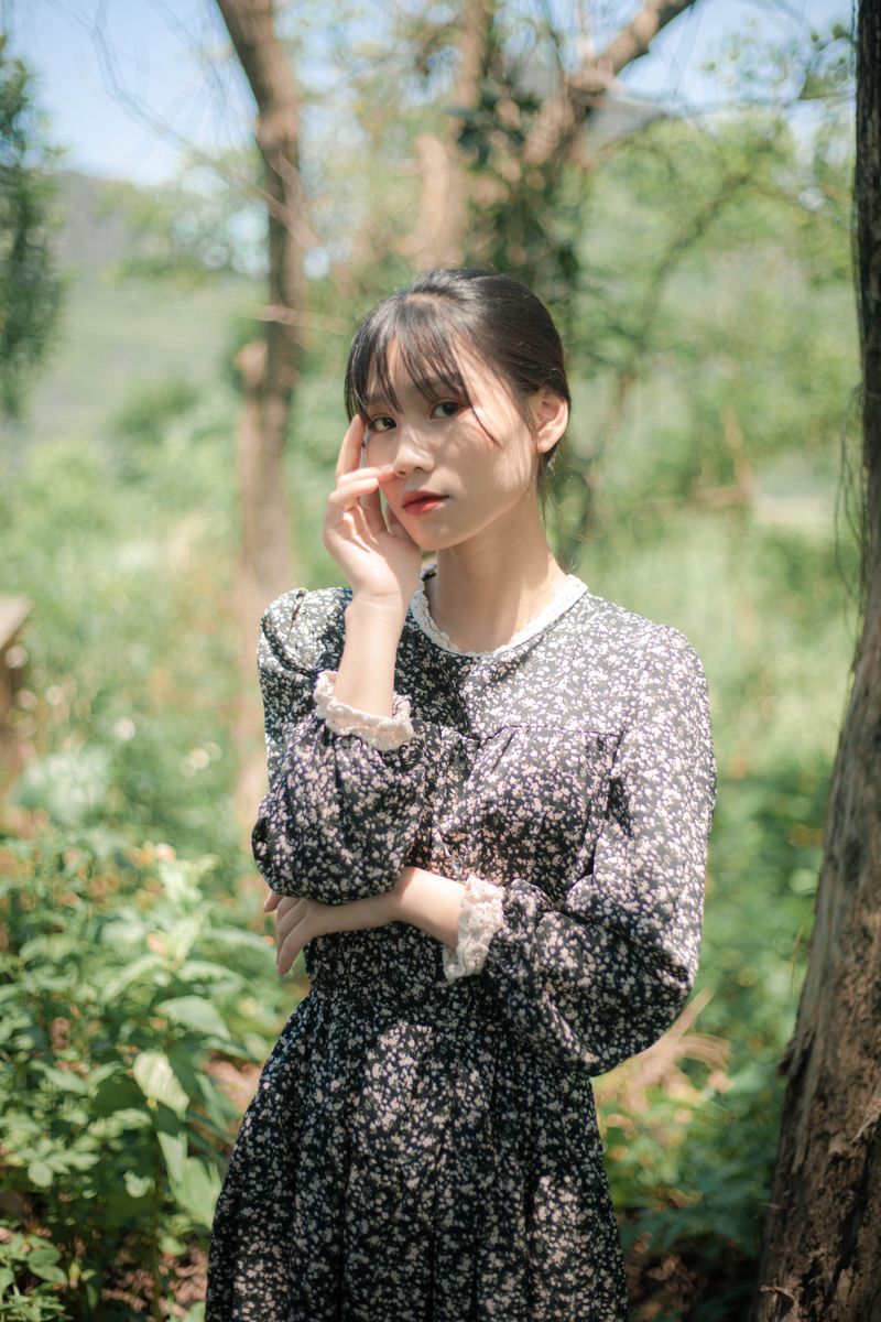 woman in a navy floral tea dress