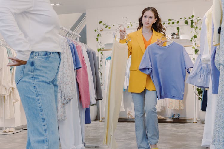 A Woman Holding Clothes With Hangers