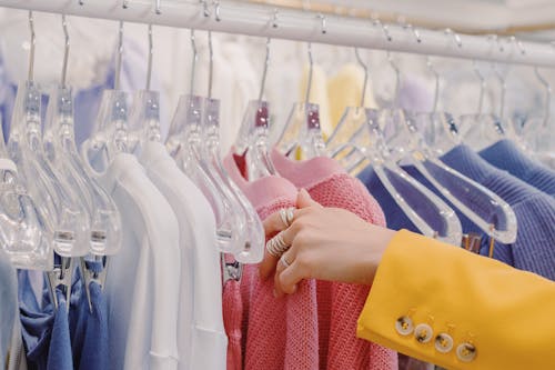Free Assorted Clothes Hanging on a Rack Stock Photo