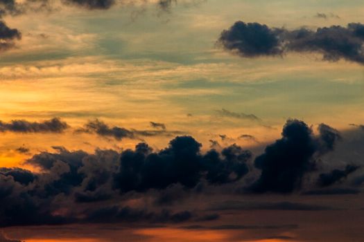 Dramatic sunset with vibrant sky and clouds, showcasing nature's beauty.