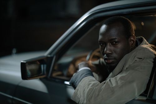 Free Portrait of a man driving a car at night, showing focus and contemplation. Stock Photo