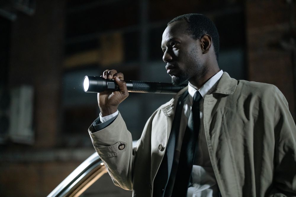 Investigator working outdoors at night with a flashlight