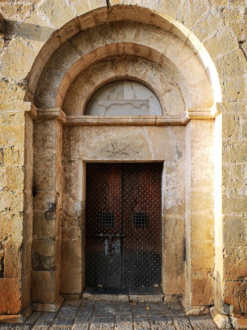 Free Gothic stone church entrance in Montagut y Oix, showcasing historic architecture. Stock Photo