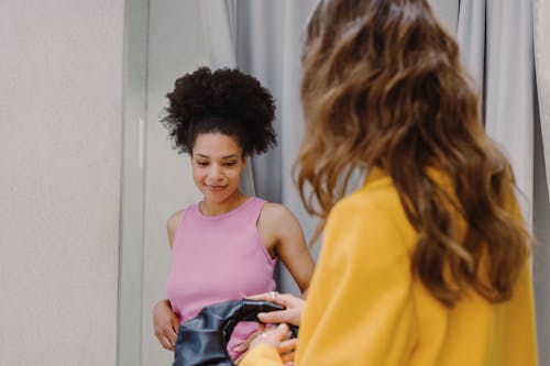 A Woman in Lilac Tank Top Near a Person in Yellow Top