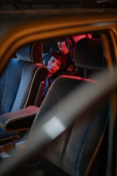 Woman Sitting in the Backseat of a Car