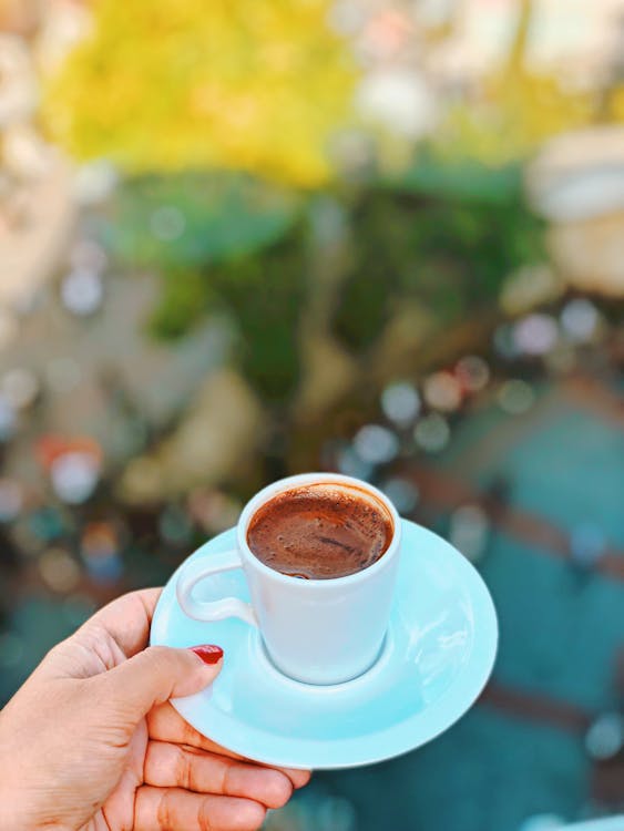 Free Person Holding a Saucer with a Cup Stock Photo