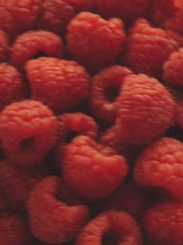 A vibrant close-up of fresh red raspberries showcasing their texture and softness.