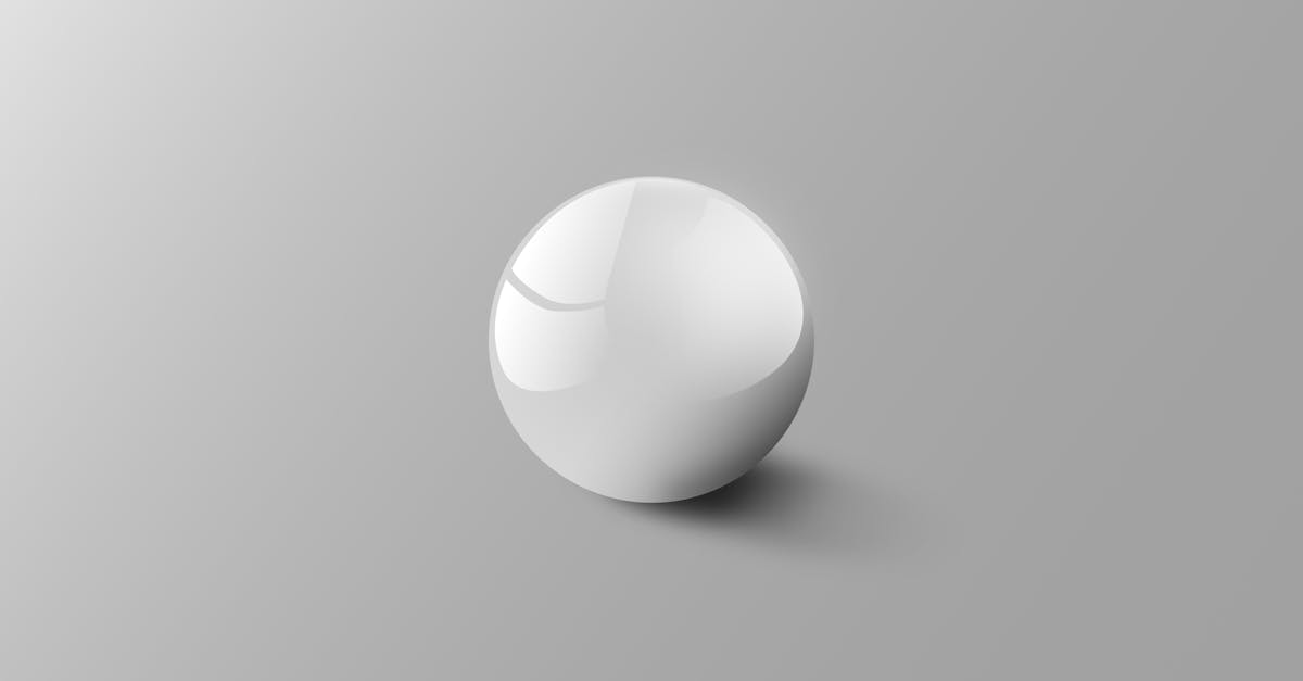 Elegant white sphere on a light grey background reflecting soft light, creating a minimalist aesthetic.