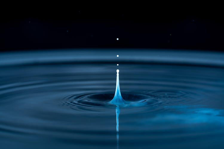 Water Drop Ripple On Black Background 