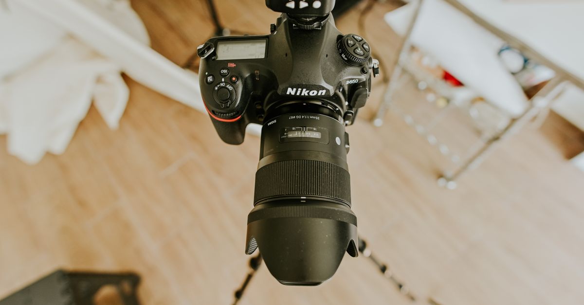 Camera on a tripod set up to photograph a bright interior