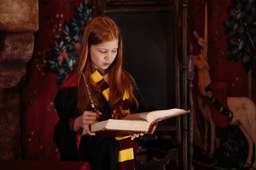 A young witch reads a spellbook in an enchanting library, immersed in wizardry.