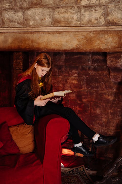 Free A Girl Reading a Book About Witchcraft Stock Photo