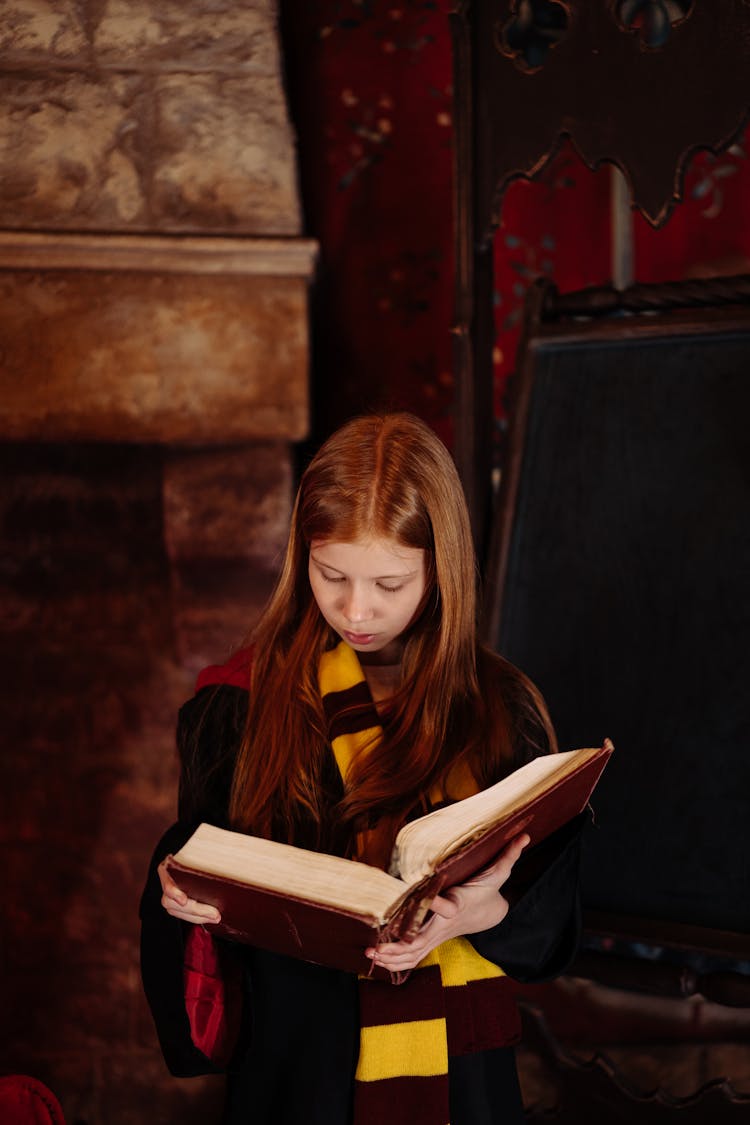 A Girl Wizard Reading A Book