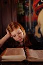 A Girl Reading a Book About Wizardry