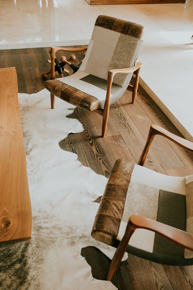 Stylish cowhide patchwork rug in a modern living room