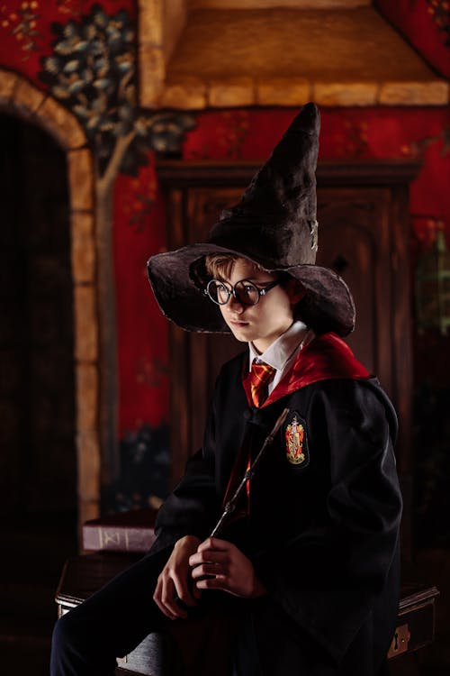 A Boy in a Harry Potter Costume Wearing the Sorting Hat · Free