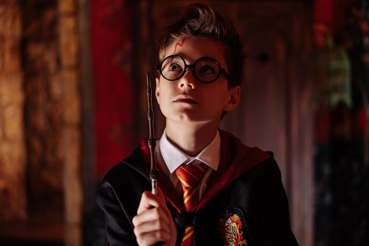 Boy In Black Framed Eyeglasses Holding A Wand