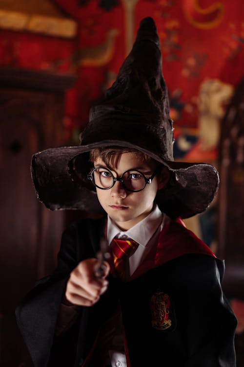 Free Kid Wearing a Costume and Holding a Wand Stock Photo
