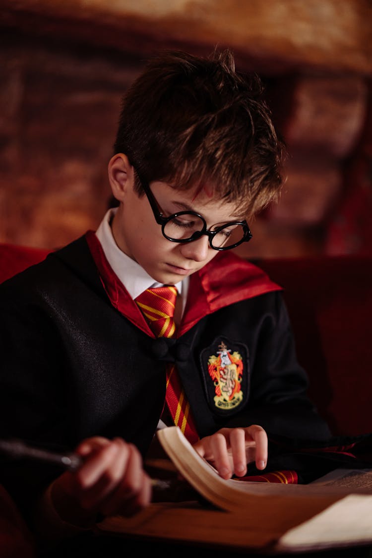 Boy In Black Framed Eyeglasses Reading A Book