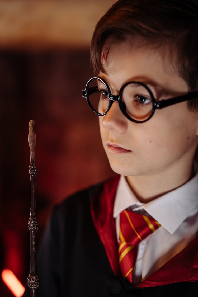 Young Man With Glasses Holding Wand