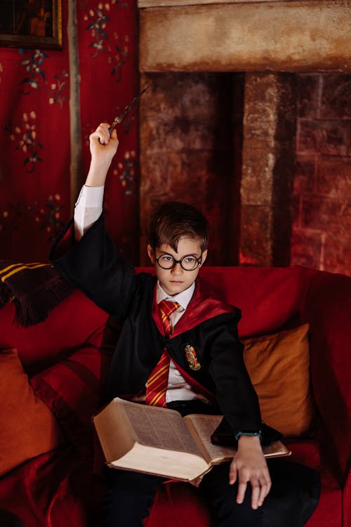 Free Kid Holding a Wand and a Book Stock Photo