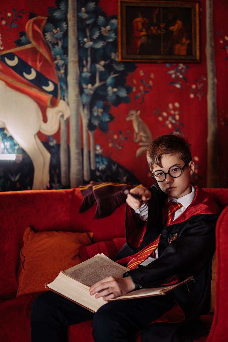 Boy In Harry Potter Costume Sitting