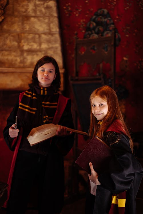 People in Black and Red Coat Carrying Books